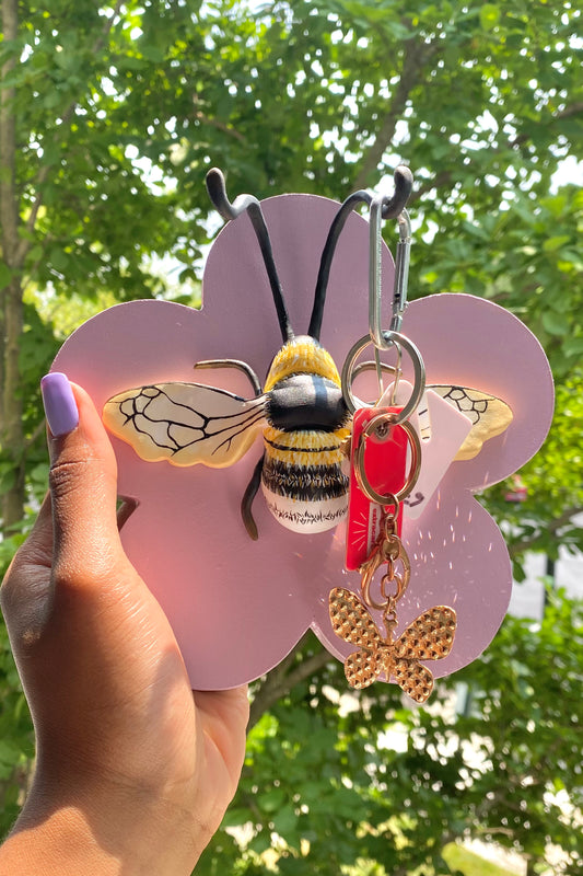 Flower shaped key rack with bumblebee decor. The antennas of the bumblebee holds the keys.